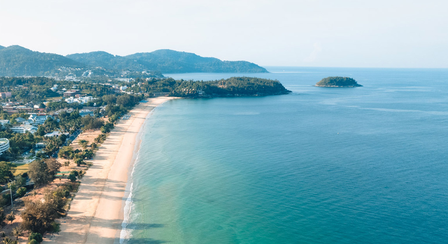 Aerial view of a beach and headland with an offshore island, near Karon