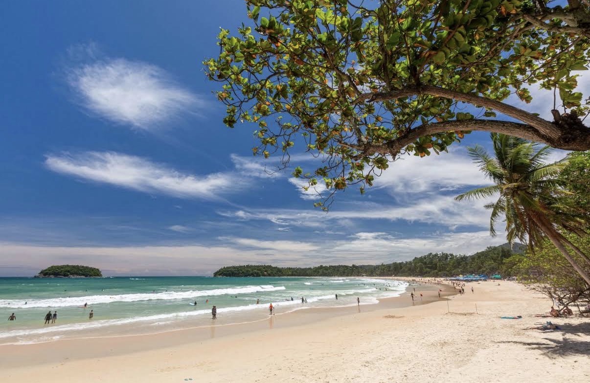 Kata Beach, Phuket, framed by trees along the shore