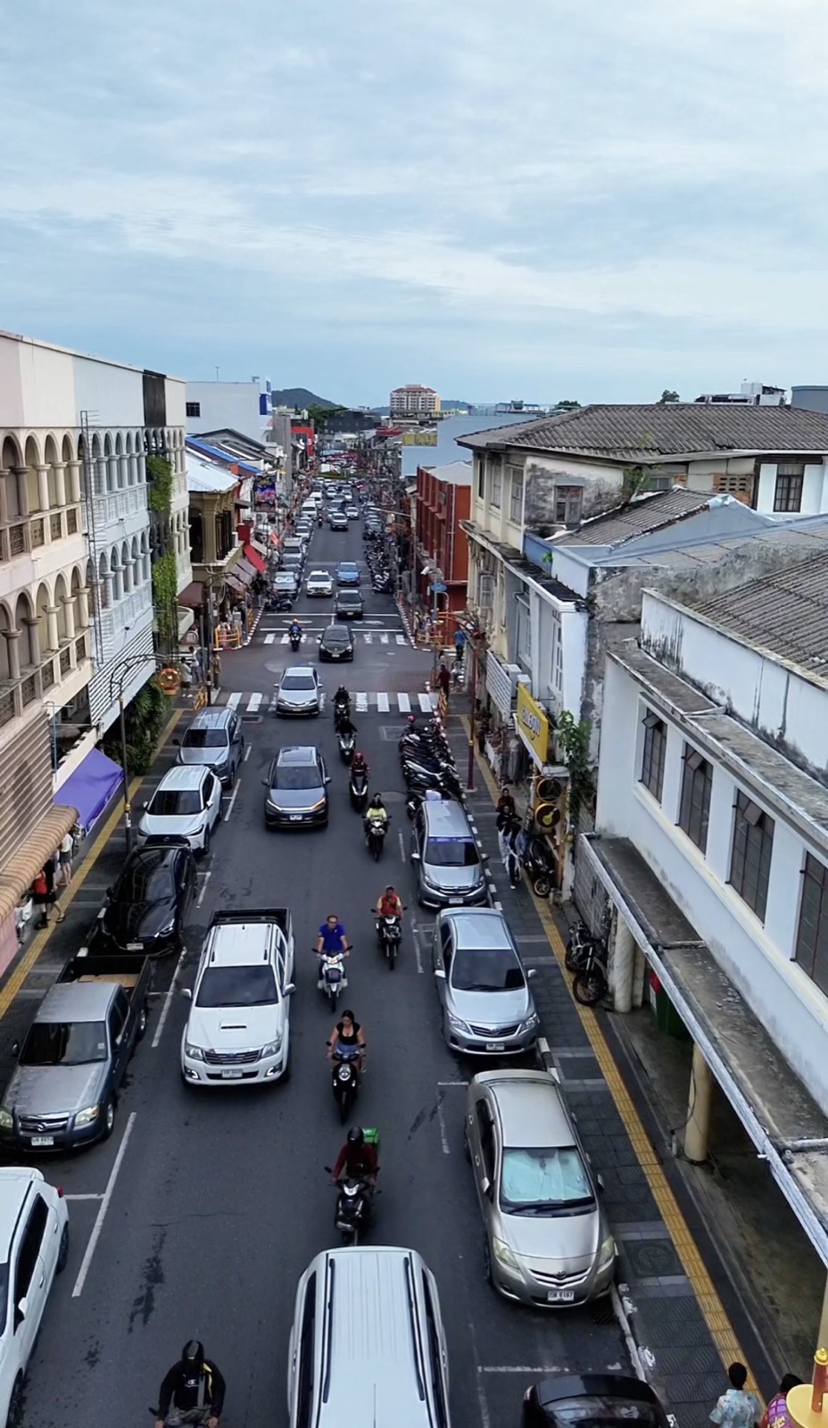 Busy street with cars and scooters in Phuket Town