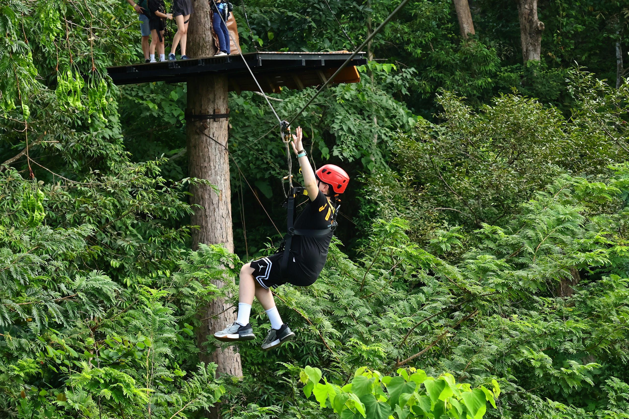 Zipline rider in the jungle canopy at Hanuman World Phuket