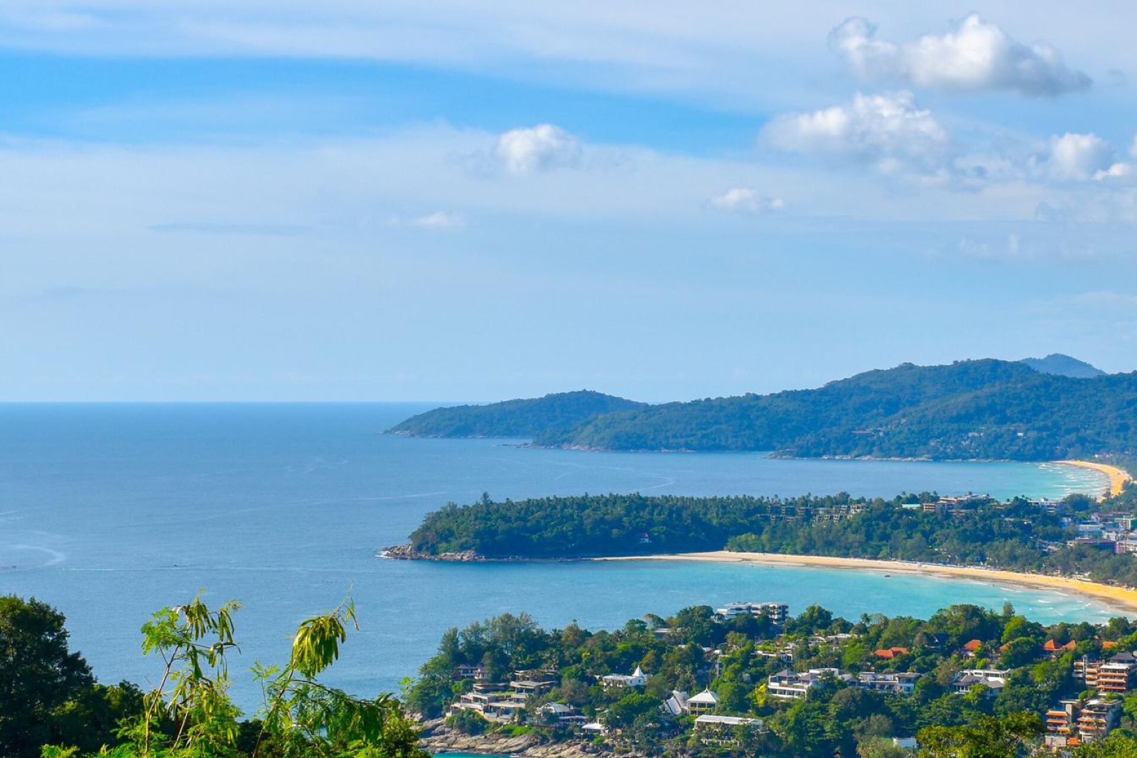 Aerial view over Phuket's west coast, showing several beaches and coves along the coastline