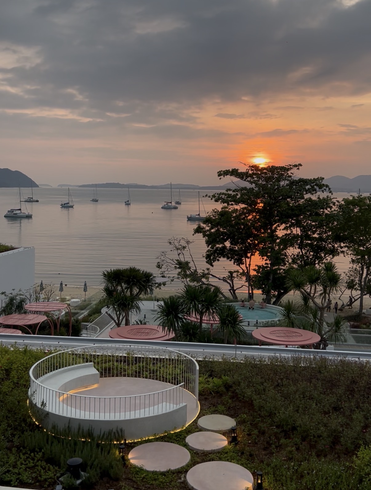 Sunset view over the bay from Veranda Resort Phuket, Cape Panwa, with moored sailboats