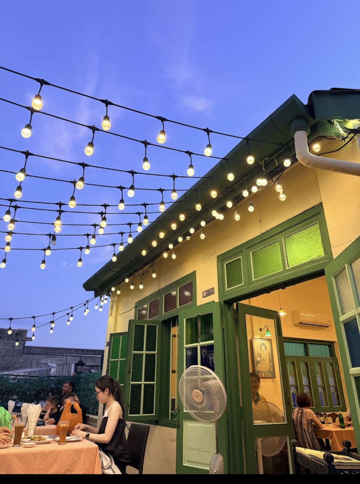 Outdoor dining area at Raya Restaurant, Phuket Old Town, strung with lights